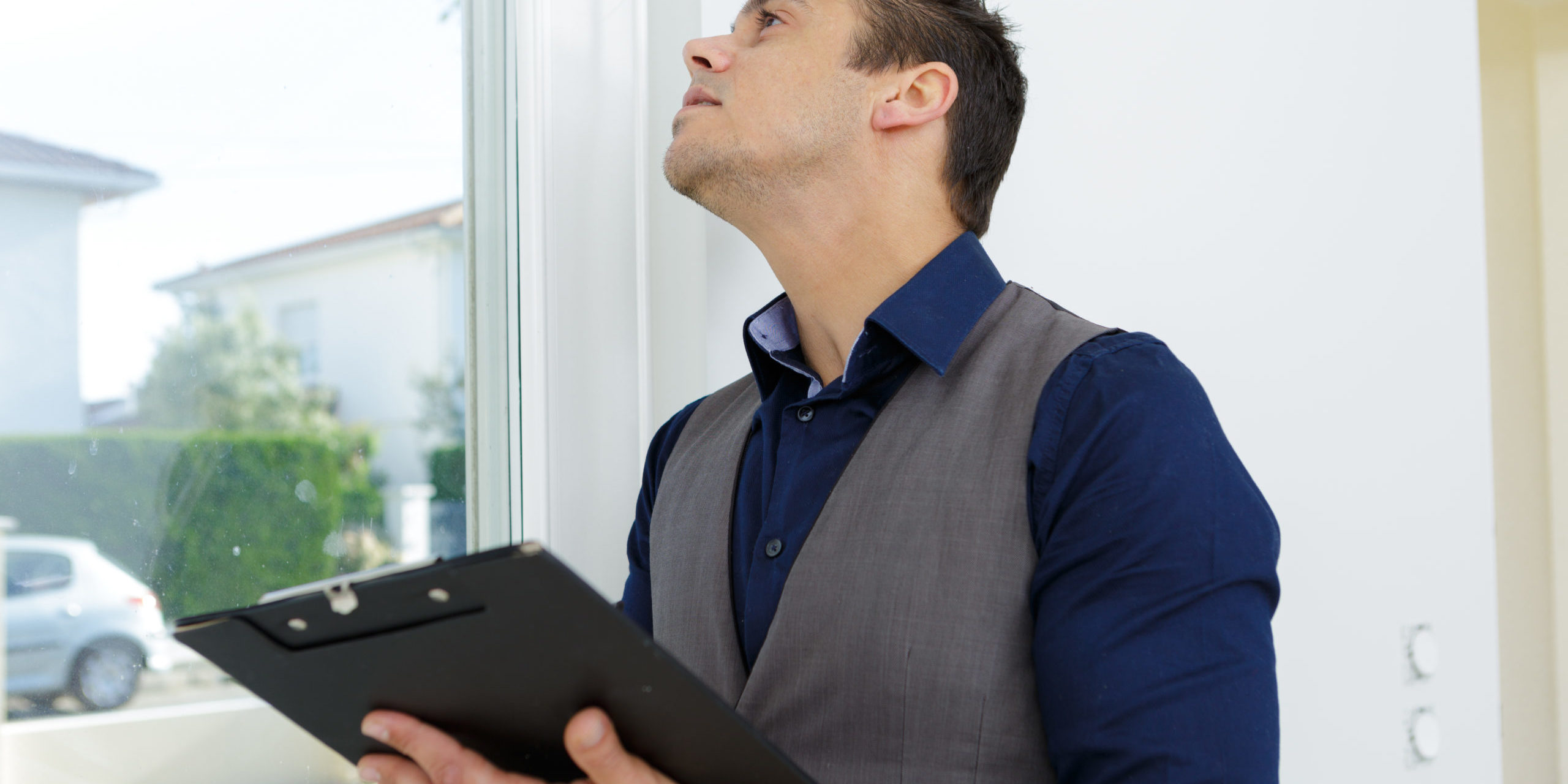 estate agent inspecting window in property Home Safety Assessment